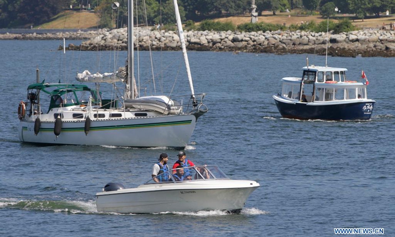 People drive their boats in waters at False Creek in Vancouver, British Columbia, Canada, on July 13, 2021. As the summer boating season ramps up and more new boaters are sharing the waterways, the Port of Vancouver reminds people it's critical time to follow the safety practices and measures to ensure everyone's safety on waterways.(Photo: Xinhua)