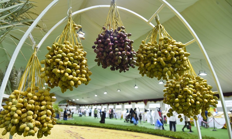 Clusters of fresh dates decorate a gate to welcome customers to the sixth Fresh Local Dates Festival at the Souq Waqif market in Doha, Qatar, on July 17, 2021. (Photo: Xinhua)