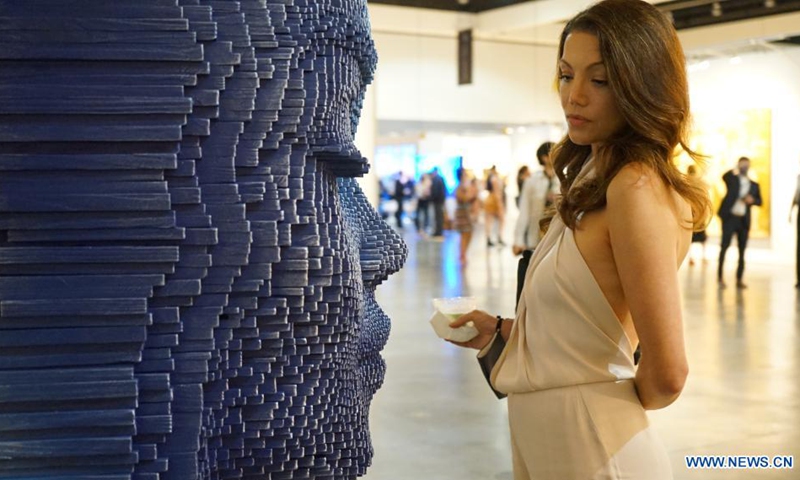 A woman visits the LA Art Show in Los Angeles, the United States, July 29, 2021. More than 80 exhibiting galleries and museums from North and South America, Asia and Europe took part in the four-day event this year.(Photo: Xinhua)