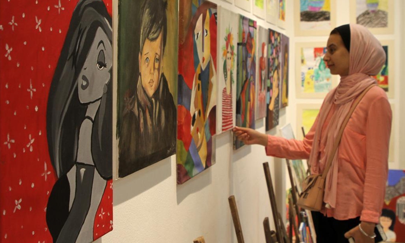 A visitor views artworks made by Palestinian children during an exhibition at Al-Qattan Center for the Child, in Gaza City, Aug. 8, 2021. About 120 children participated in the exhibition with their artworks.(Photo: Xinhua)