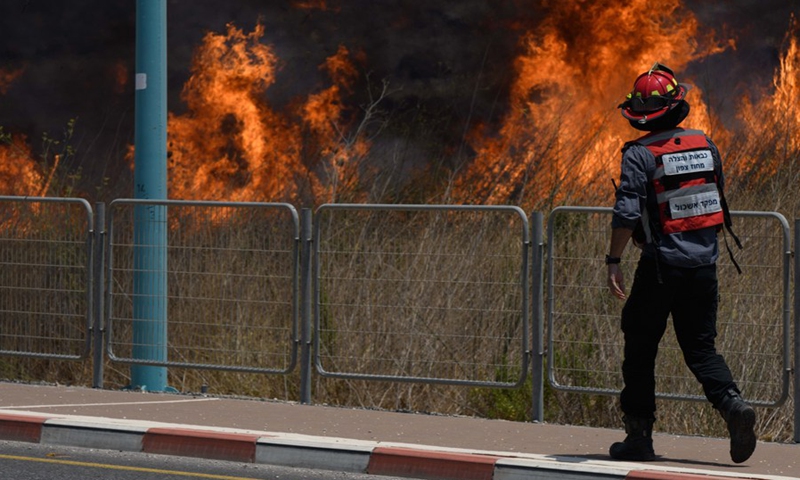 A fire caused by rockets launched from Lebanon into Israel is seen raging near northern Israeli city of Kiryat Shmona, on Aug. 4, 2021.(Photo: Xinhua)