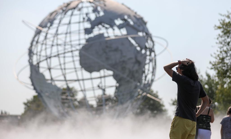 People cool off in the mist garden near the Unisphere in Flushing Meadows Corona Park in New York, the United States, Aug. 13, 2021. A heat wave recently hit New York City.Photo:Xinhua