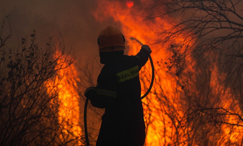 A firefighter battles against a wildfire at Varybobi, Acharnes, Greece, on Aug. 3, 2021.(Photo: Xinhua)