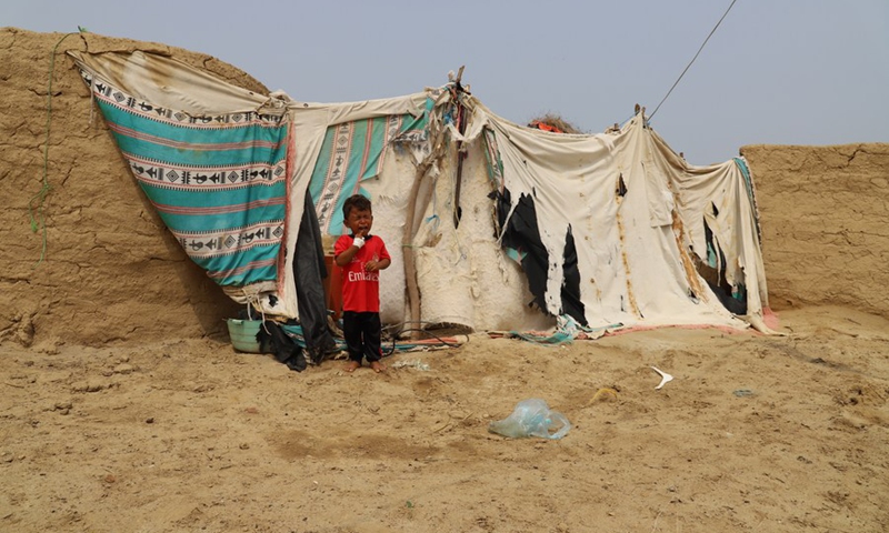 A boy stands in front of his family's tent inside a remote village in Midi District, Hajjah Province, north Yemen on Aug. 14, 2021. (Photo: Xinhua)