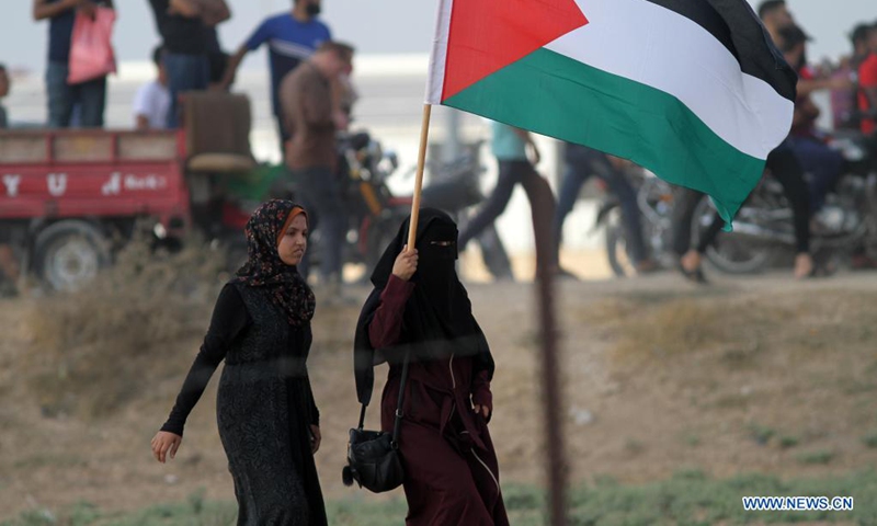 Palestinian women take part in a protest to mark 52nd anniversary of burning Al-Aqsa Mosque in East Jerusalem, on the Gaza-Israel border in east of southern Gaza Strip city of Khan Younis, Aug. 21, 2021. Dozens of Palestinian protesters were injured on Saturday in clashes with Israeli soldiers near the border between eastern Gaza Strip and Israel, Palestinian medics said.(Photo: Xinhua)