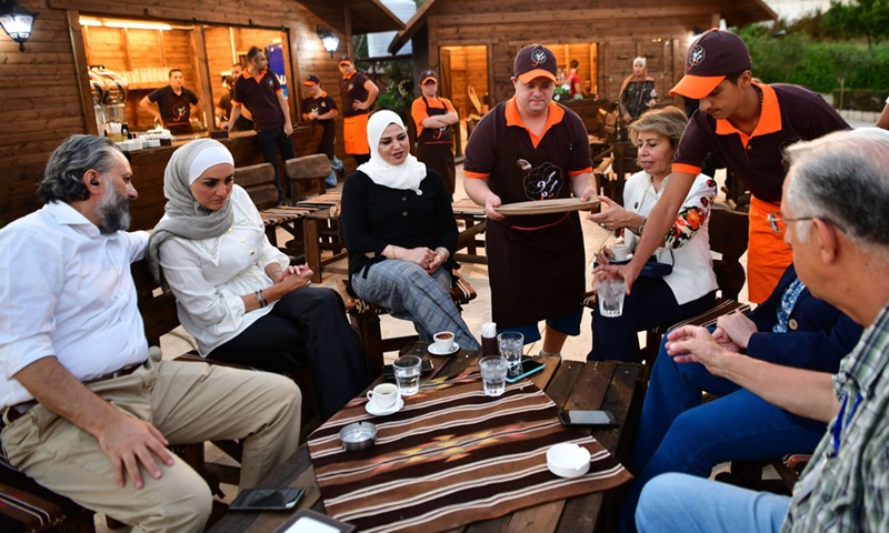 Young Syrians with Down Syndrome work at a cafe called Sucette in the capital Damascus on Aug. 21, 2021.(Photo: Xinhua)