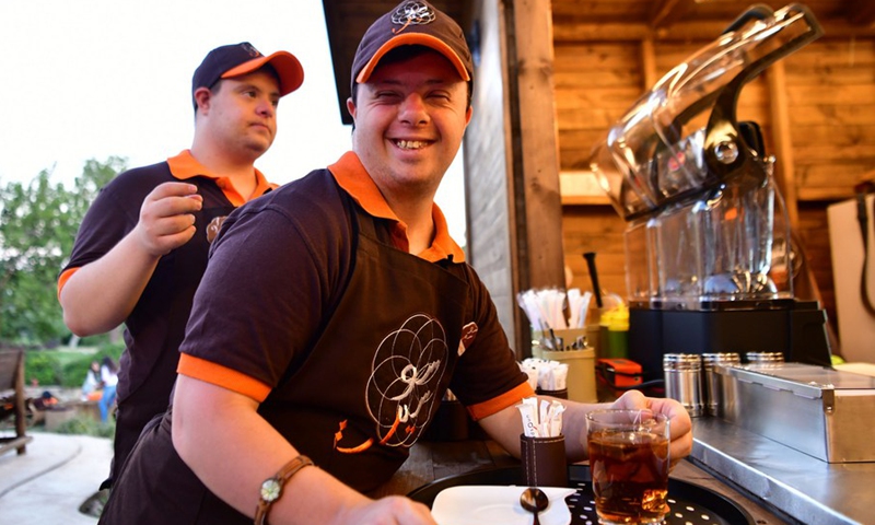 Young Syrians with Down Syndrome work at a cafe called Sucette in the capital Damascus on Aug. 21, 2021.(Photo: Xinhua)