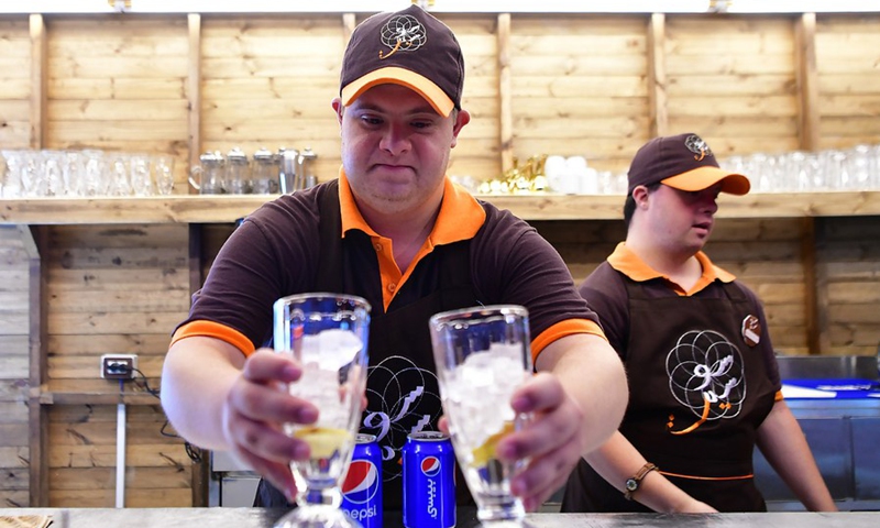 Young Syrians with Down Syndrome work at a cafe called Sucette in the capital Damascus on Aug. 21, 2021.(Photo: Xinhua)