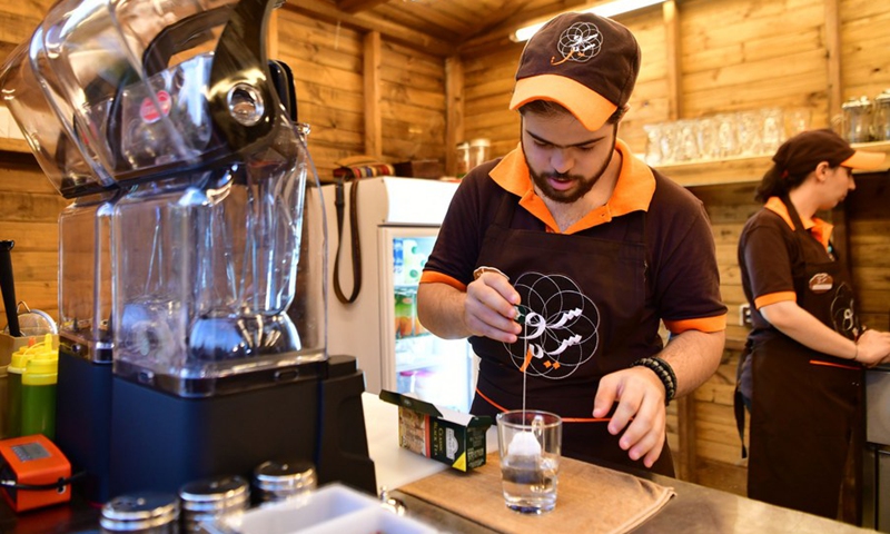 Young Syrians with Down Syndrome work at a cafe called Sucette in the capital Damascus on Aug. 21, 2021.(Photo: Xinhua)