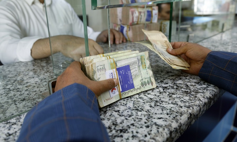 A Yemeni man exchanges for cash inside a foreign exchange center in Sanaa, Yemen on Aug. 24, 2021.(Photo: Xinhua)