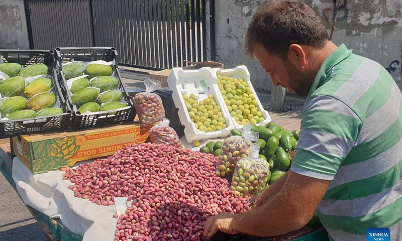 A vendor sells fresh pistachios on the roadside in Nabatiyeh, Lebanon, Aug. 27, 2021. In the Middle East, people call pistachio the smiling nut because the split shell resembles a smile. The cultivation of pistachio began to recover and expand in Lebanon several years ago, benefiting from the assistance of local and international agricultural associations.(Photo: Xinhua)