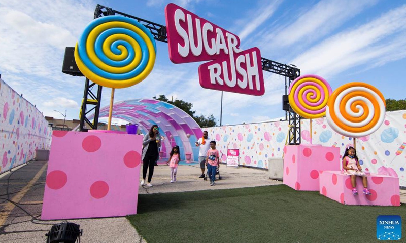 People visit the Sugar Rush theme park in Mississauga, Ontario, Canada, on Sept. 3, 2021. Offering an immersive open-air experience, the sugar-themed park invites visitors to walk among all sorts of candies in different colors, shapes and sizes here from Aug. 6 to Sept. 6 this year.Photo:Xinhua