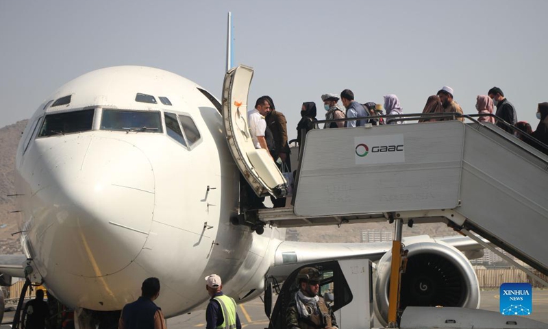 Passengers board a plane at the airport in Kabul, capital of Afghanistan, Sept. 6, 2021. Afghanistan's flag carrier airline Ariana Afghan Airlines has resumed domestic flights, a local television channel reported Sunday.(Photo: Xinhua)