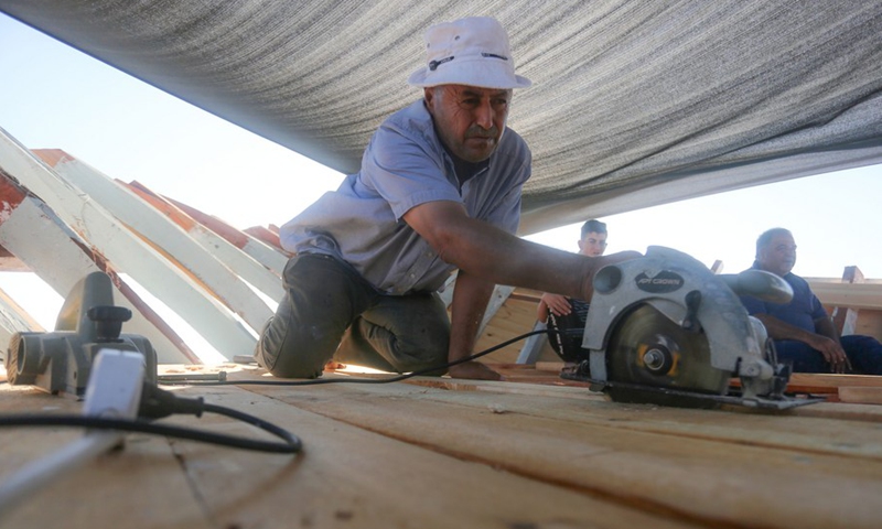 Palestinian boat maker Abdullah Al-Najjar makes a new boat at a port in the southern Gaza Strip city of Khan Younis, on Sept. 5, 2021.(Photo: Xinhua)