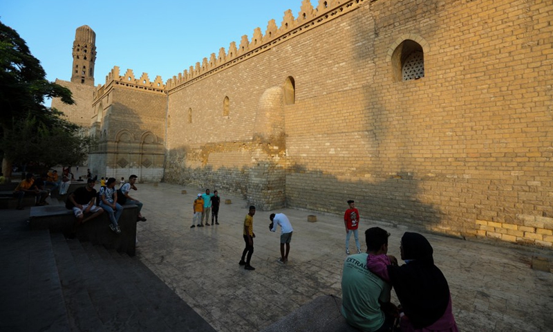 People enjoy themselves beside a mosque in Historic Cairo, Egypt, on Sept. 11, 2021.(Photo: Xinhua)