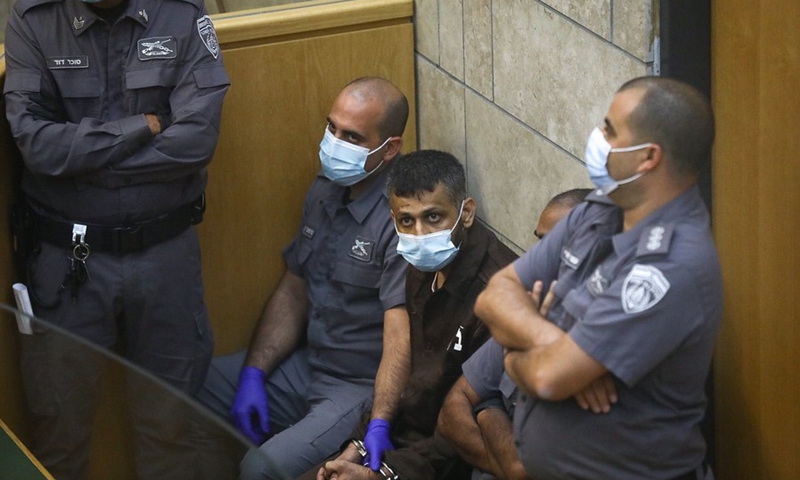 Mohammad Ardah (3rd L), one of the six prisoners who escaped from a high-security Israeli prison, makes his first appearance at an Israeli court after recapture in Nazareth, Israel, Sept. 11, 2021.(Photo: Xinhua)