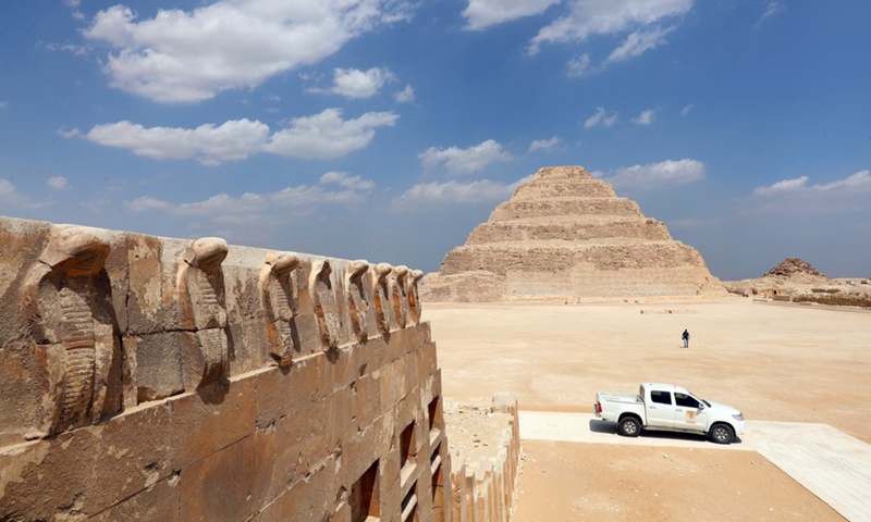 Photo shows cobra heads decorated on the wall of stone buildings on the upper level of the south tomb of King Djoser with the Step Pyramid in the distance in Saqqara necropolis, south of Cairo, Egypt, on Sept. 14, 2021.(Photo: Xinhua)