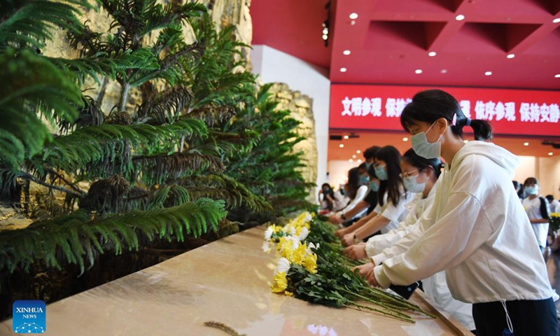 Visitors present flowers to pay tribute to revolutionary martyrs at the Museum of the War of Chinese People's Resistance Against Japanese Aggression in Beijing, capital of China, Sept. 18, 2021. Various activities are held on Sept. 18 in commemoration of the September 18 Incident 90 years ago that marked the start of Japan's 14-year invasion of China. Photo:Xinhua