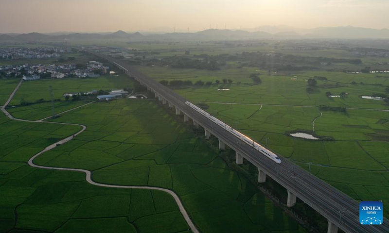 Aerial photo taken on Sep 19, 2021 shows a bullet train running above paddy fields in Gula Township, Binyang County, south China's Guangxi Zhuang Autonomous Region.Photo:Xinhua