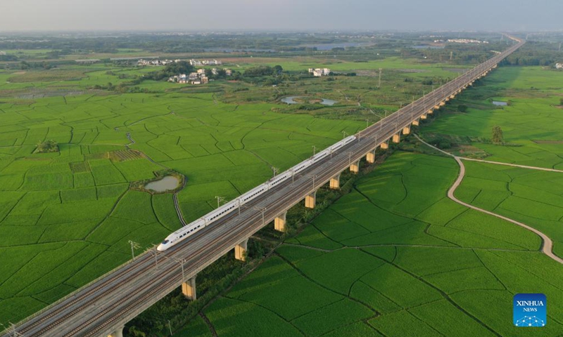 Aerial photo taken on Sep 19, 2021 shows a bullet train running above paddy fields in Gula Township, Binyang County, south China's Guangxi Zhuang Autonomous Region.Photo:Xinhua