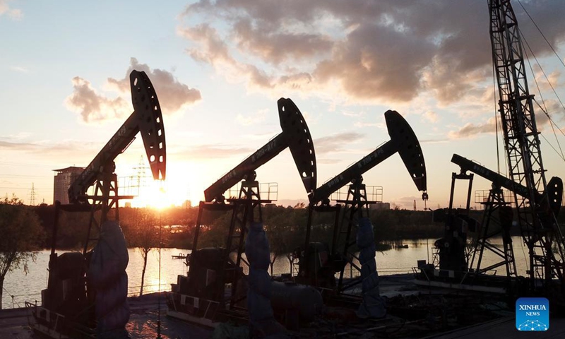 Aerial photo shows the sunset view of Daqing Oilfield in Daqing, northeast China's Heilongjiang Province, May 24, 2021. China's Daqing Oilfield announced on Aug. 25 the discovery of a major shale oil field with predicted geological reserves of about 1.27 billion tonnes. Discovered in 1959, Daqing Oilfield has made a significant contribution to China's modern petroleum industry system. It also steps up efforts to improve its ecological environment in recent years.(Photo: Xinhua)