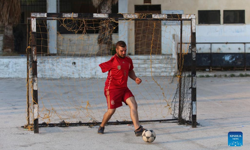 Oday Nasser trains at a small stadium in Deir Sharaf village in the West Bank city of Nablus, on Sept. 15, 2021. Without an arm, Oday Nasser has become an outstanding goalkeeper known across the West Bank, who managed to win dozens of medals in the local football league. (Photo: Xinhua)