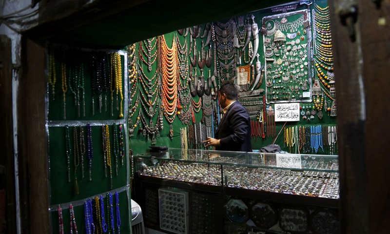 A seller of Yemeni traditional handicrafts stands inside his store in the Old City of Sanaa, capital of Yemen, on Sept. 27, 2021. (Photo: Xinhua)