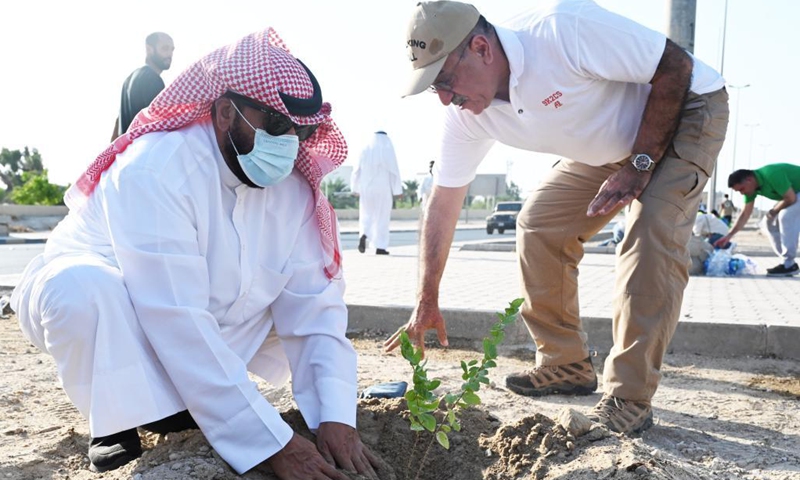 People plant a sapling during a tree-planting campaign in Capital Governorate, Kuwait, on Oct. 2, 2021. Kuwait launched on Saturday a tree-planting campaign in the Capital Governorate in an endeavor to address climate challenges. (Photo: Xinhua)