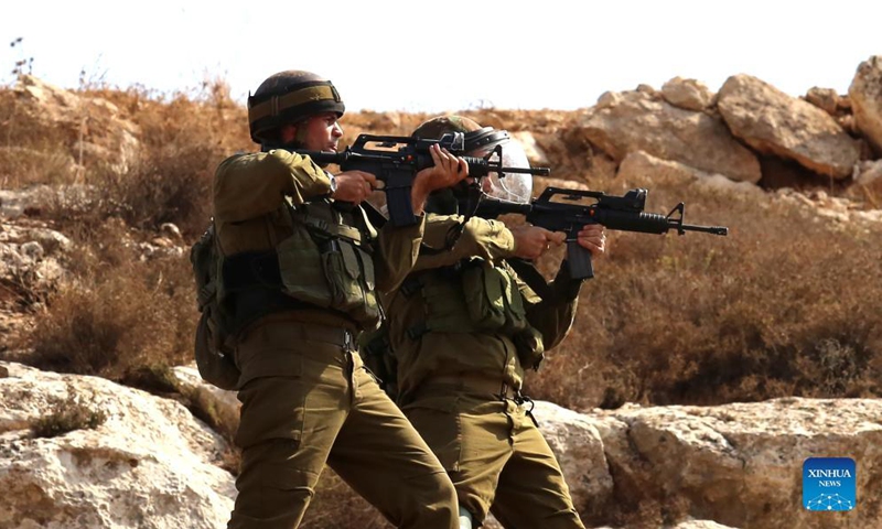 Israeli soldiers aim at Palestinian protesters during a protest against the expansion of Jewish settlements in the West Bank village of Beit Dajan, east of Nablus, Oct. 15, 2021.Photo:Xinhua