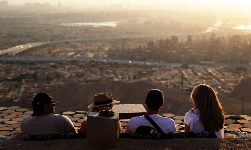 Tourists enjoy the sunset glow at the Mokattam Corniche in Cairo, Egypt, on Oct. 17, 2021.(Photo: Xinhua)