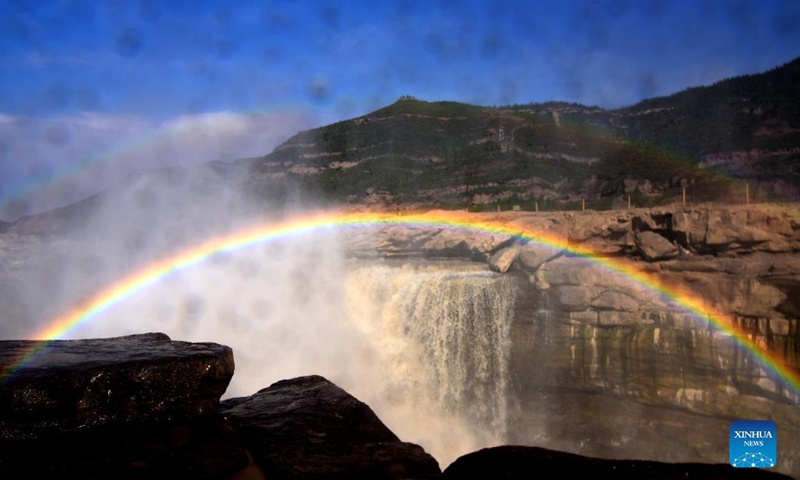 Photo taken on Oct. 18, 2021 shows a rainbow over the Yellow River's Hukou Waterfall in northwest China's Shaanxi Province. (Photo: Xinhua)