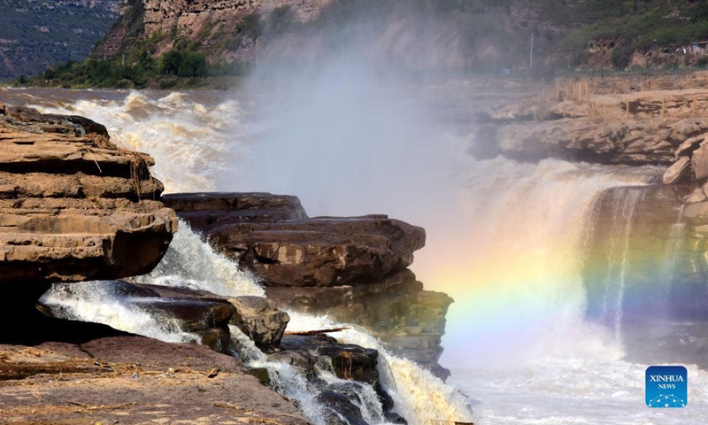 Photo taken on Oct. 18, 2021 shows a rainbow over the Yellow River's Hukou Waterfall in northwest China's Shaanxi Province. (Photo: Xinhua)