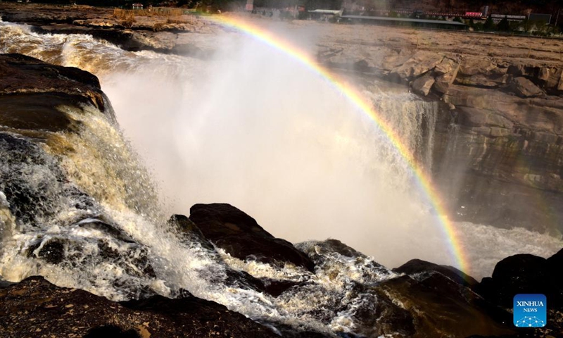 Photo taken on Oct. 18, 2021 shows a rainbow over the Yellow River's Hukou Waterfall in northwest China's Shaanxi Province. (Photo: Xinhua)