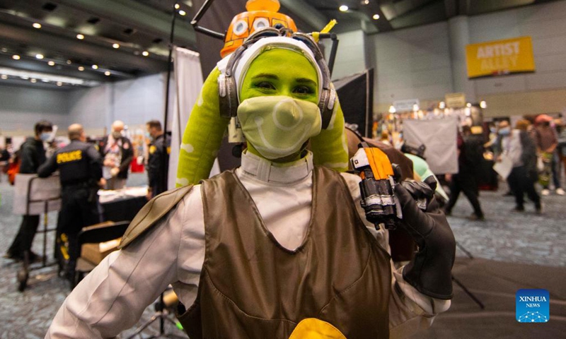 A cosplayer poses for photos during the 2021 Fan Expo Canada at the Metro Toronto Convention Center (MTCC) in Toronto, Canada, on Oct. 22, 2021. As one of the largest Comics, Sci-Fi, Anime and Gaming events in North America, this event is held here from Friday to Sunday.(Photo: Xinhua)