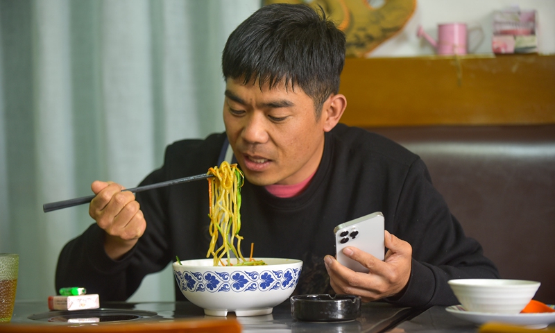 Wang Xianjun enjoys Chinese noodle at a restaurant named Xinjiang Restaurant Zhua Fun in Addis Ababa, Ethiopia, Oct. 11, 2021.(Photo: Xinhua)