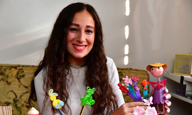 Sandra Baghdan, a fresh university graduate, makes small toys with recycled paper in Damascus, Syria on Nov. 4, 2021. (Photo: Xinhua)