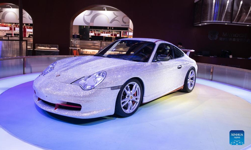 Photo taken on Nov. 5, 2021 shows a Porsche sports car decorated with gems at the Consumer Goods Exhibition Area of the 4th China International Import Expo (CIIE) in east China's Shanghai. The Porsche car is decorated with nearly 400,000 gems, which were made by craftsmen by hand for several months.Photo:Xinhua