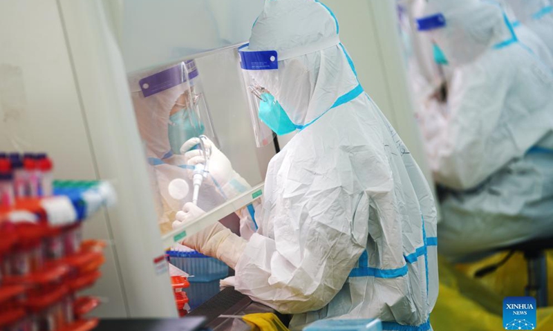 Medical workers work inside an air-inflated film chamber of a mobile laboratory for nucleic acid test in Harbin, northeast China's Heilongjiang Province, Nov. 5, 2021.Photo:Xinhua