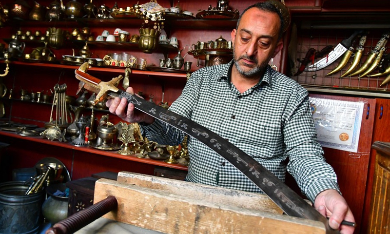 A sword maker works at his workshop in Damascus, Syria, Nov. 10, 2021.(Photo: Xinhua)