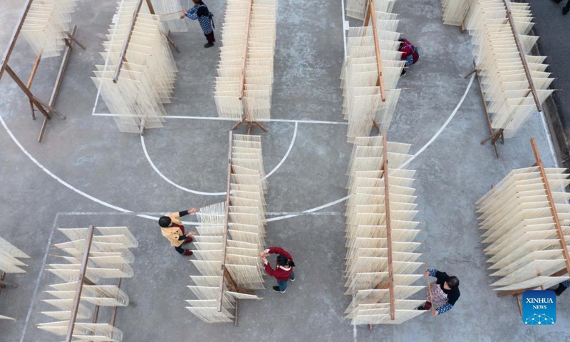 Aerial photo shows villagers drying handmade noodles in Huyuan Township of Fuyang District, Hangzhou City, east China's Zhejiang Province, Nov. 16, 2021. Noodle culture festival, noodle making activity, intangible cultural heritage performance and other events have been held in Huyuan Township in recent years, as efforts to promote the development of agricultural and rural tourism industries. (Xinhua)