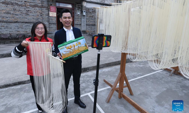 Li Rong (R) and Guo Hongmei sell handmade noodles via live streaming in Huyuan Township of Fuyang District, Hangzhou City, east China's Zhejiang Province, Nov. 16, 2021. Noodle culture festival, noodle making activity, intangible cultural heritage performance and other events have been held in Huyuan Township in recent years, as efforts to promote the development of agricultural and rural tourism industries.  (Xinhua)