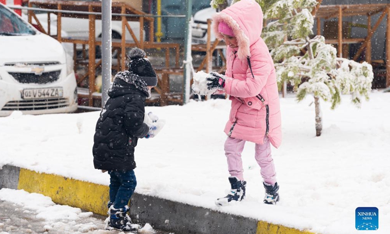 Children play in the snow in Tashkent, Uzbekistan, Nov. 17, 2021. Tashkent witnessed a snowfall on Wednesday. (Xinhua)