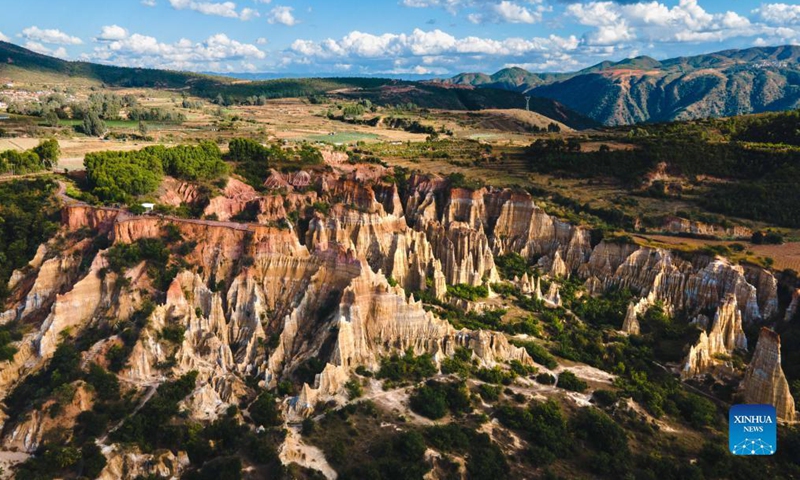 Photo taken on Nov. 17, 2021 shows the scenery of earth forest in Yuanmou County, southwest China's Yunnan Province. The earth forest, which was formed by geological movement and soil erosion, is basically in color of yellow and the color varies in different parts.(Xinhua)