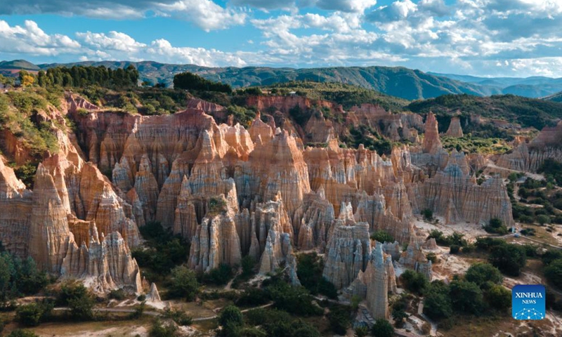 Photo taken on Nov. 17, 2021 shows the scenery of earth forest in Yuanmou County, southwest China's Yunnan Province. The earth forest, which was formed by geological movement and soil erosion, is basically in color of yellow and the color varies in different parts. (Xinhua)