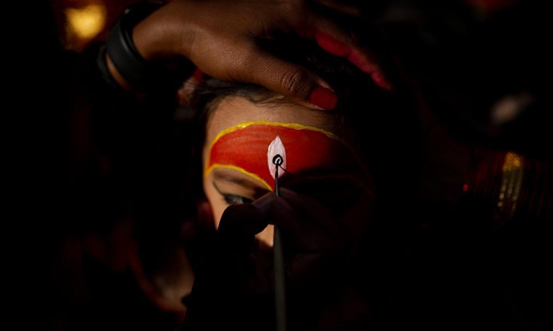 A girl is prepared for a Hindu holy ritual on the occasion of World Children's Day in Kathmandu, Nepal on Nov. 20, 2021.Photo:Xinhua