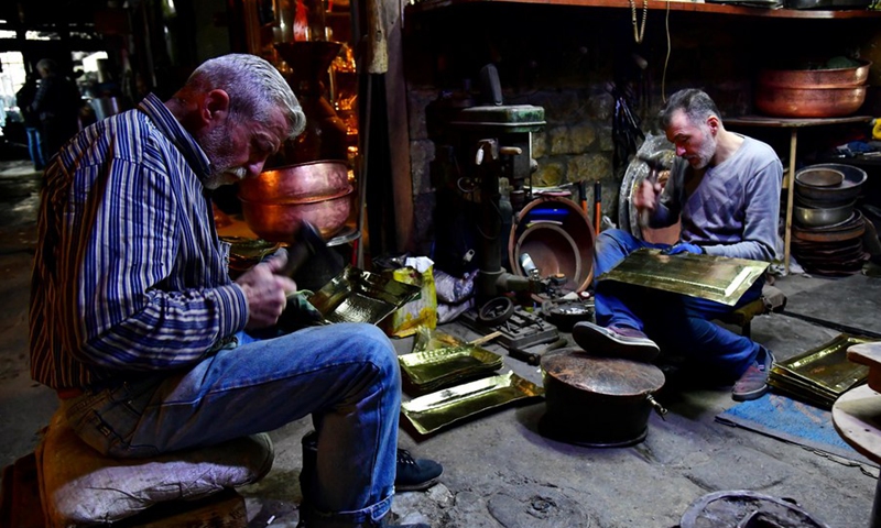 Craftsmen make copperware at a workshop in Damascus, Syria, on Nov. 28, 2021.(Photo: Xinhua)