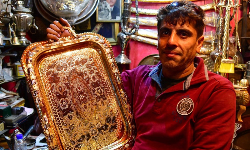 A craftsman shows copperware at a workshop in Damascus, Syria on Nov. 28, 2021.(Photo: Xinhua)