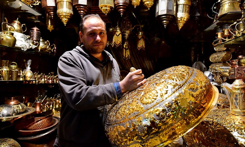 A craftsman shows a copper handicraft at a workshop in Damascus, Syria, on Nov. 28, 2021.(Photo: Xinhua)