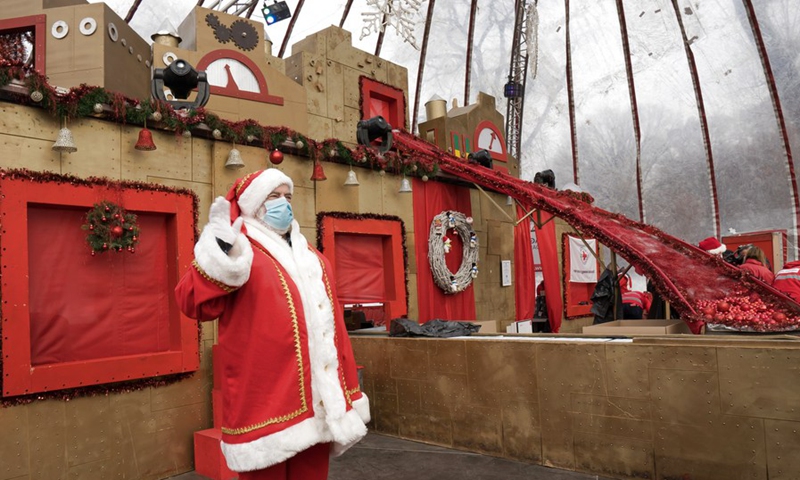 A man dressed as Santa Claus attends the opening of the Santa factory, a Christmas-related charity to collect donations for children in need, in Budapest, Hungary, on Dec. 1, 2021.(Photo: Xinhua)