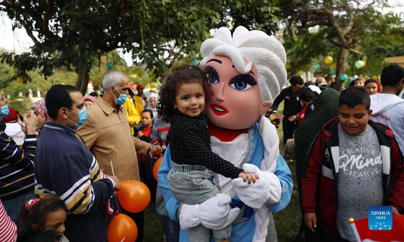 A performer holds a girl in arms during a gathering to mark the International Day of Persons with Disabilities at Merryland Park in Cairo, Egypt, on Dec. 3, 2021.Photo:Xinhua